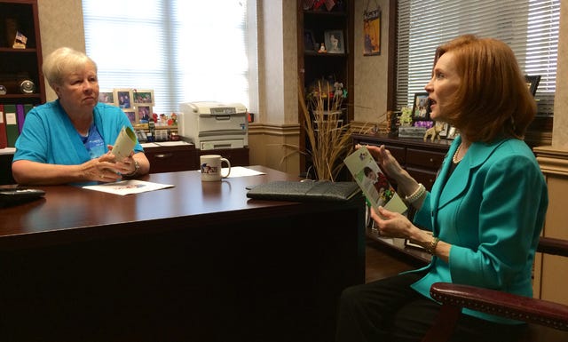 Justin Bates Times Record / Beth Anne Rankin, with the Arkansas State Treasurer's Office, speaks to Sebastian County Treasurer-Collector Judith Miller about a college savings program on Wednesday, April 8, 2015.