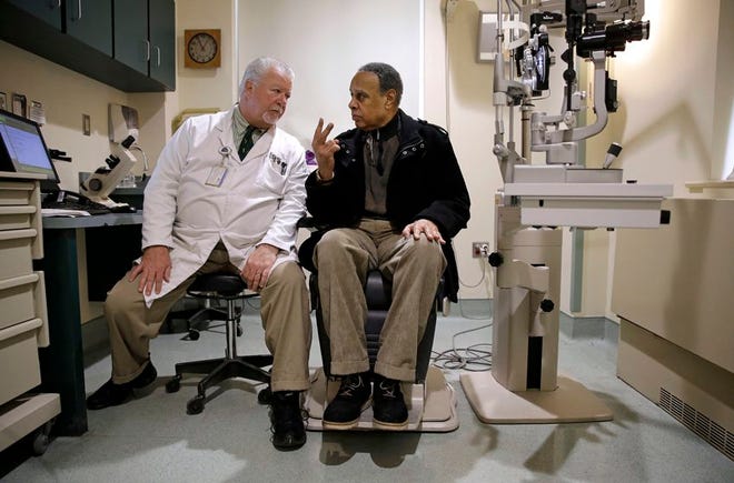 In this March 12 photo, optometrist Paul Archambault, left, talks with U.S. Army veteran Kenneth Chavis during a glaucoma examination at the Fayetteville Veterans Affairs Medical Center in Fayetteville, N.C. (AP Photo/Patrick Semansky)