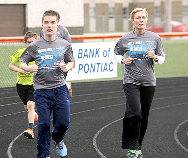 Mitch Kelley, left, who was featured in last year’s Spread the Word to End the Word video, “My Son” participated in the 1-mile fun run with his mother, Lisa Kelley.