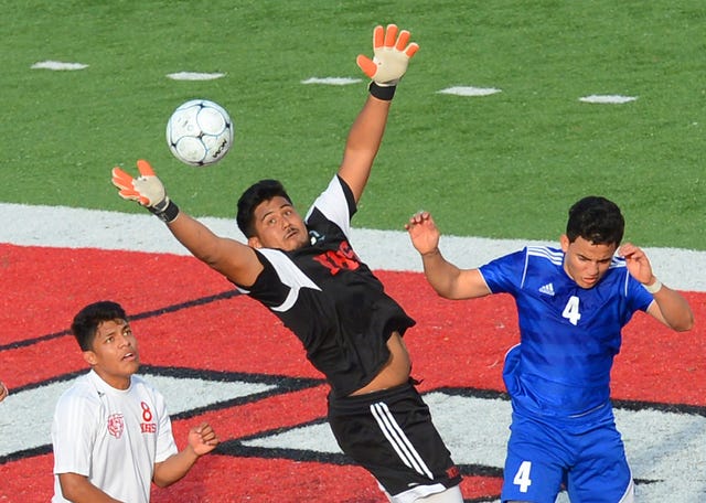 BRIAN D. SANDERFORD • TIMES RECORD Northside goalkeeper Jose de Jesus Parga, center, makes a save on a Rogers corner kick between teammate Jorge Campos, left, and Rogers' Bayron Anderson during the first half on Thursday, April 9, 2015 at Mayo-Thompson Stadium. 
 BRIAN D. SANDERFORD • TIMES RECORD Northside’s Jose Luis Ramirez heads the ball away from the Northside goal on Thursday, April 9, 2015 during a match against Rogers at Mayo-Thompson Stadium.