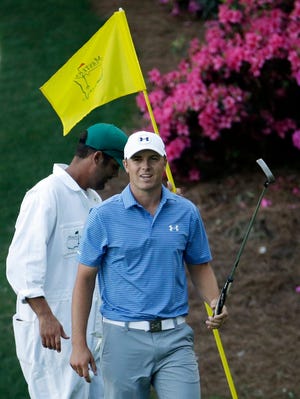 Jordan Spieth acknowledges applause after a birdie on the 13th green during the third round of the Masters golf tournament Saturday, April 11, 2015, in Augusta, Ga.