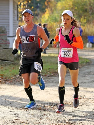 Mark and Tammy Arsenault approach the end of the 2014 Loco Half Marathon. Mark is training for this year's Boston Marathon with Will Locandro and Tim Finelli. COURTESY PHOTO