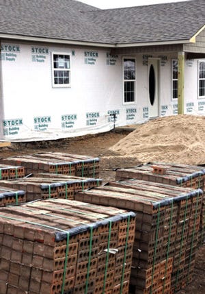 TIMES RECORD FILE PHOTO / Brick are set at the site of a new home under construction on Tennessee Ridge Road in Fort Smith in January 2013.