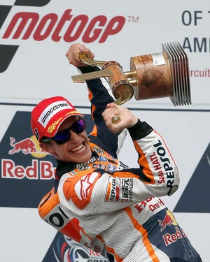 Marc Marquez celebrates with the trophy after he claimed the MotoGP event in Austin, Texas, on Sunday.