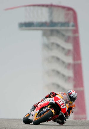 Marc Marquez, of Spain, leans during qualifying for the MotoGP Grand Prix of the Americas motorcycle race at the Circuit of the Americas, Saturday, April 11, 2015, in Austin, Texas. Marquez earned the pole position for Sunday's race. (AP Photo/Darren Abate)
