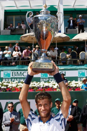 Martin Klizan of Slovakia poses with the trophy after he won the men's final of the Hassan II Grand Prix tennis tournament, in Casablanca, Morocco, Sunday, April 12, 2015. Martin Klizan defeated Spain's Daniel Gimeno-Traver 6-2. 6-2. (AP Photo/ Abdeljalil Bounhar)