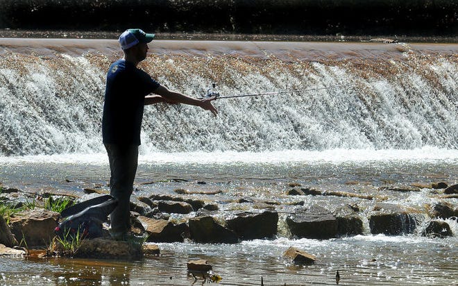 Matthew Marks, of Moorestown, fishes for large mouth bass in the township's Strawbridge Lake on Monday.
