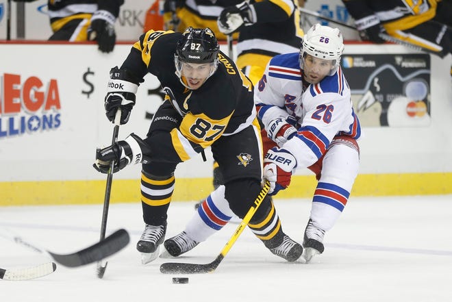 Pittsburgh Penguins' Sidney Crosby (87) and New York Rangers' Martin St. Louis are paired up in the first round of the NHL playoffs once again. The seven-game series begins Thursday. (AP Photo/Keith Srakocic, File)