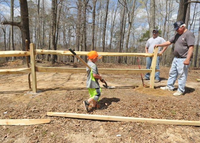 C.J. Kraus, 5, hauls rocks for a new fence as employees of the Wal-Mart Distribution Center and family members helped Friends of the Lower Appomattox River with a batch of projects at Ferndale Park in Dinwiddie Monday, April 6. The park will host FOLAR's Lower Appomattox RiverFest on Saturday, April 25.

Patrick Kane/Progress-Index Photos
