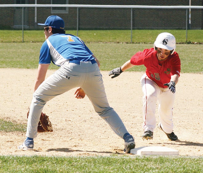 Stark County’s Taran Sisk dives back into first base as Galva’s Billy Comer takes the throw during Saturday’s LTC doubleheader.