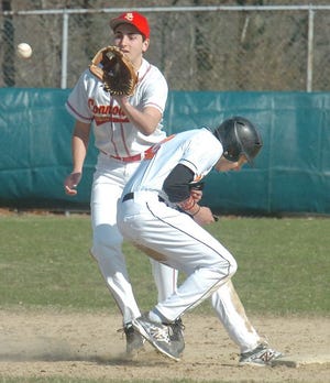 Diman's Austin Crowninshield ducks back to first base as Bishop Connolly's Alec Kfoury prepares to snare the throw during the second inning on Monday.