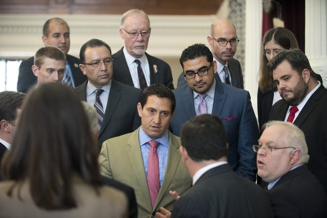 San Antonio Democratic Rep. Trey Martinez Fischer, center, confronts state Rep. Larry Phillips, R-Sherman, with a Point of Order on HB 910 that delayed the open carry gun bill on April 14.