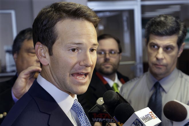 In this Feb. 6, 2015, file photo, Rep. Aaron Schock, R-Ill. speaks to reporters in Peoria Ill. According to a source, the Justice Department is investigating possible criminal violations by resigning Illinois congressman. (AP Photo/Seth Perlman, File)