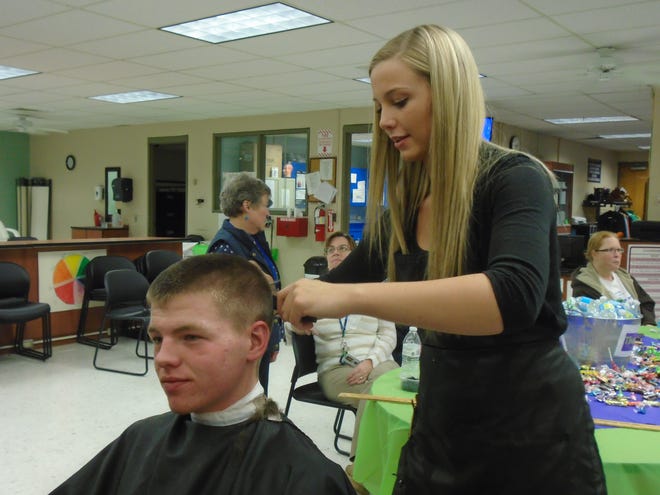 Cosmetology student Kim Monroe, of Millis, cuts her brother Joseph’s hair during a charity Cut-A-Thon and Style-A-Thon held in the school’s salons on Friday, April 10. CONTRIBUTED PHOTO