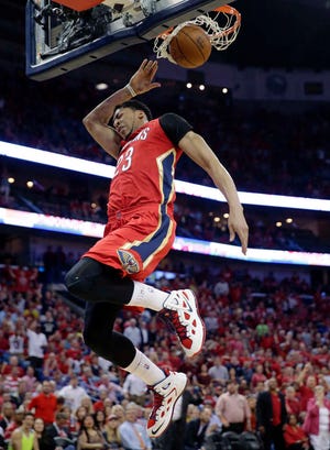New Orleans's Anthony Davis dunks for two of his 31 points Wednesday night as the Pelicans clinched the final playoff spot in the West. He also added 13 rebounds.