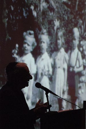 Holocaust survivor Daniel Goldsmith talks about his experiences surviving the Nazis in World War II during a Holocaust Remembrance Ceremony service on Wednesday, April 15, 2015 at Ohev Shalom in Northampton. This photo shows him with his siblings, before they were split up by his parents for safety.