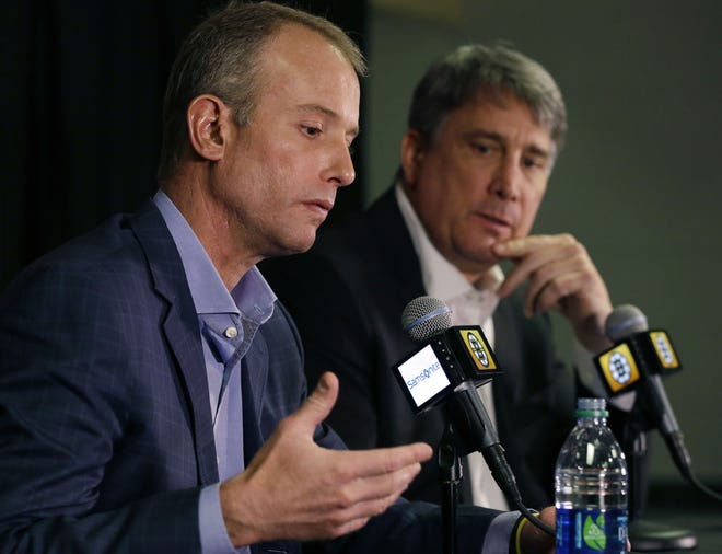 Bruins chief executive officer Charlie Jacobs (left) and president Cam Neely speak during a news conference in Boston on Wednesday about the team's decision to fire general manager Peter Chiarelli.