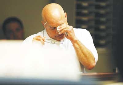 Photo by Daniel Freel/New Jersey Herald - Jeffrey Muller, a Newton business owner who was abducted in 2010, wipes away tears as he testifies on Tuesday in state Superior Court in Newton during the trial of one of his alleged abductors, Douglas Stangeland.
