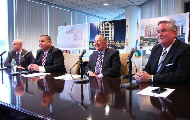 Quincy Mayor Thomas Koch, second from left, introduces three projects for Quincy Center on Tuesday, April 7, 2015. He's joined by developers, from left, Alex Matov, Peter O'Connell and Sean Galvin. Two of the projects would involve city-owned land, and thus would require land-disposition agreements approved by the city council.