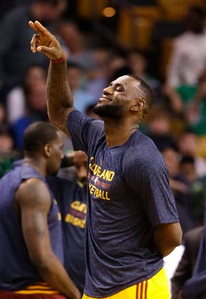 The Cavaliers' LeBron James waves from the court during a timeout in the fourth quarter of Sunday's game in Boston.