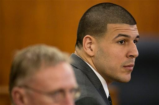 Former New England Patriots NFL football player Aaron Hernandez listens during his murder trial at the Bristol County Superior Court in Fall River, Mass., on Wednesday. Hernandez is accused of killing Odin Lloyd in June 2013.