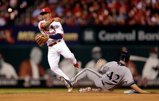Milwaukee Brewers' Logan Schafer, right, is out at second as St. Louis Cardinals second baseman Kolten Wong fails to turn the double play during the ninth inning of a baseball game Wednesday, April 15, 2015, in St. Louis. The Brewers' Carlos Gomez was safe at first and the Cardinals went on to win 4-2. (AP Photo/Jeff Roberson)