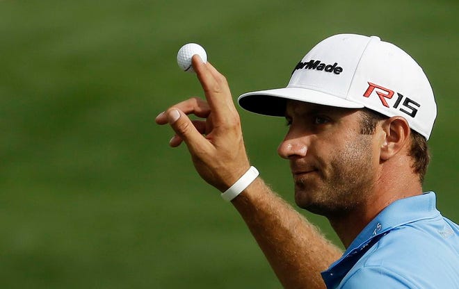 Dustin Johnson holds up his ball after a birdie on the 15th hole during the second round of the Masters golf tournament Friday, April 10, 2015, in Augusta, Ga. (AP Photo/Darron Cummings)