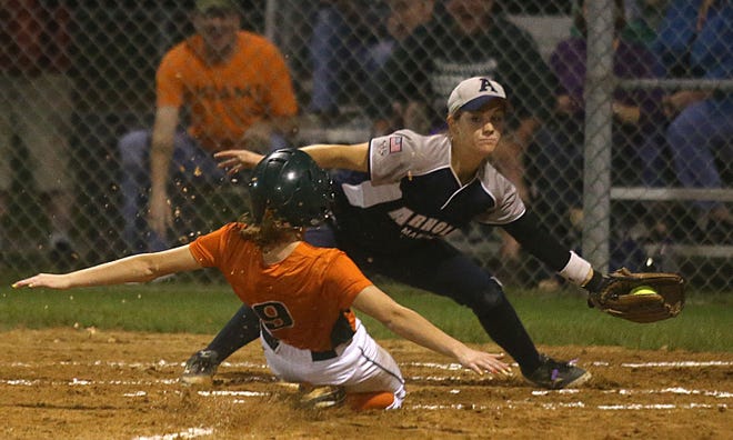 Arnold's Summer Simmons tags out Mosley's Hannah Bload during Tuesday's District 1-5A tournament game.
