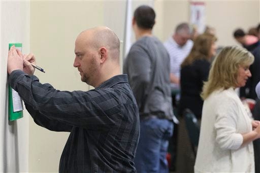 In this April 2, 2015 photo, Daniel Marquardt from LaFayette, Ga., fills out an application during a huge 15-county job fair in Ringgold, Ga. The Labor Department releases weekly jobless claims on Thursday, April 9, 2015. (AP Photo/Chattanooga Times Free Press, Dan Henry)