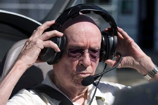 In this March 30, 2015, photo, Peter Weber Jr., 95, puts on headphones before a flight in Placerville, Calif. The Sacramento Bee reported that Weber's flight made him the world's oldest active pilot, according to the Guinness World Record keepers. (Randy Pench/The Sacramento Bee via AP)