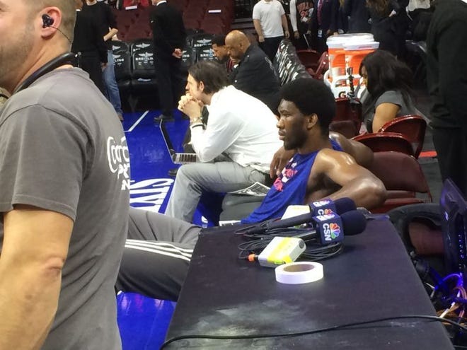 Injured Sixers rookie center Joel Embiid takes a breather following a March 11 pregame workout.