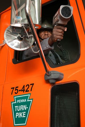 (file) Trooper First Class Charles Bailey demonstrates the use of a radar gun from a construction vehicle after a press conference Thursday, April 16, 2015.