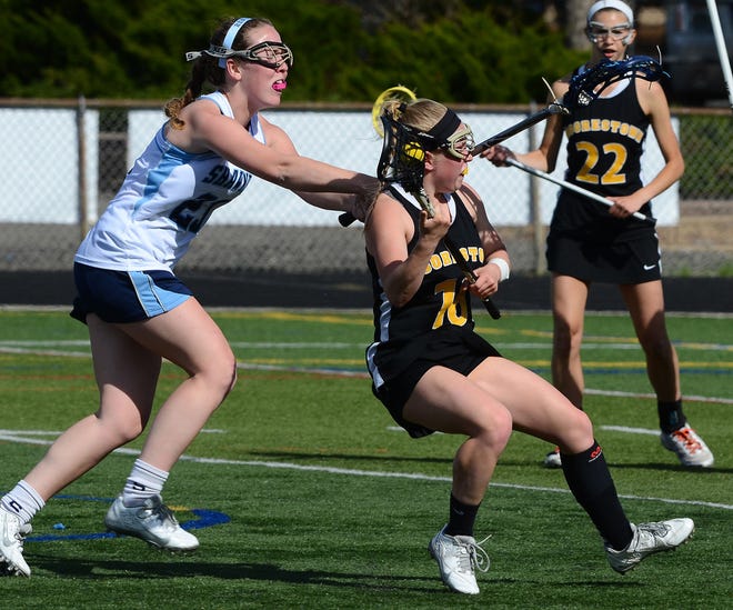 First half action, Thursday, Apnee'sril 16, 2015 had Moorestown's 18 Abbey Brooks keeping her balance while being attacked by Shawnee's 23 Bridget O'Hanlon.
