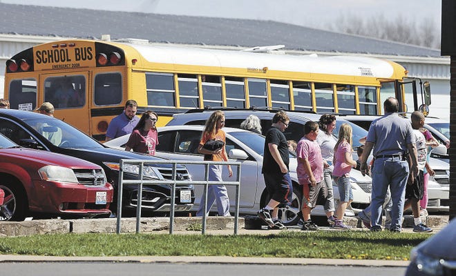 John Lovretta/The Hawk Eye Students head back into the Dallas City Elementary School after area law enforcement agencies responded Thursday to a 911 call about a potential intruder. Students were evacuated and placed on school buses while the school was searched thoroughly, but no intruder was discovered. Hancock County Sheriff Scott Bentzinger said officers from Hancock County Sheriff's Office responded to the call, as well as officers from Henderson County, Oquawka, Illinois State Police, Hamilton, Nauvoo, La Harpe and Carthage.