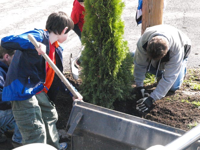 Boy Scout Joey Mongiovi joins kneeling worker Brian Bond, director of Stroudsburg Public Works, planting trees at last year’s Arbor Day event.

Photo provided
