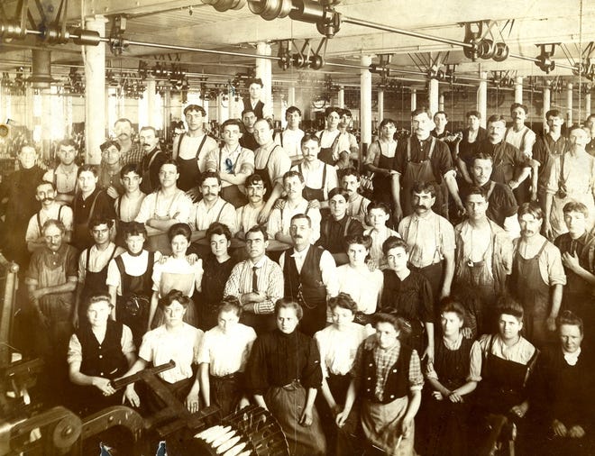 New Bedford textile workers pose for a group photo in mill in this photograph from the collection of the New Bedford Whaling Museum, where a new exhibition, "Energy and Enterprise: Industry and the City of New Bedford,” is opening to the public Friday.

COURTESY PHOTO