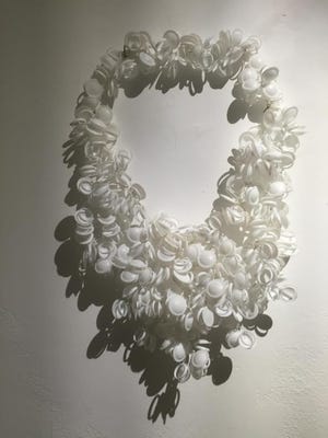 Dartmouth artist created this elaborate necklace, "Cleoplastica," out of pull-tabs from milk bottles. An exhibition of her works is on view in Providence.

COURTESY PHOTO