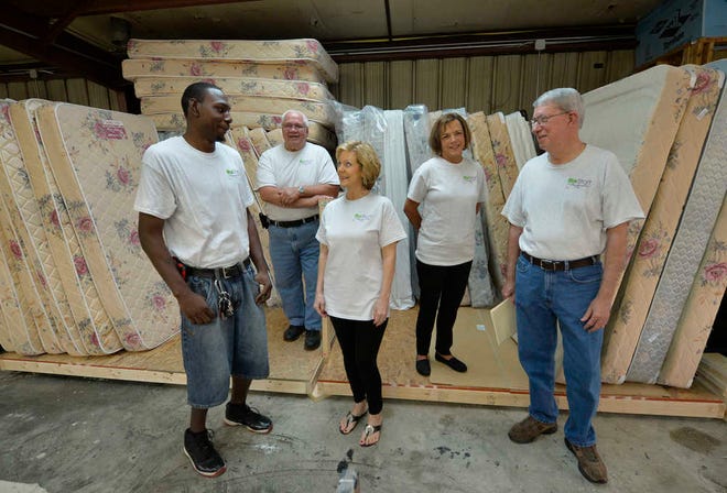 ReStart Augusta leaders Chris Shelley (from left), Daryl Morse, Glenda Metts Hill, Pat Williams and Larry Dinkins at the group's bed-making facility in Augusta. Volunteers build and assemble beds for people who need them.
