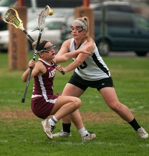 Abington's Casey McCalister is knocked down by Pennsbury's Isabel Glace during a girls lacrosse game in Falls Township on Friday April 17, 2015.