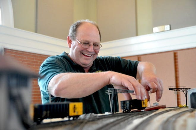 Jim Howell, a member of the Lehnis Heart of Texas Model Railroad Club, places an HO scale model railroad car on the track Friday afternoon at the Depot Cultural Center in preparation of this weekend’s Heart of Texas Railroad Festival.