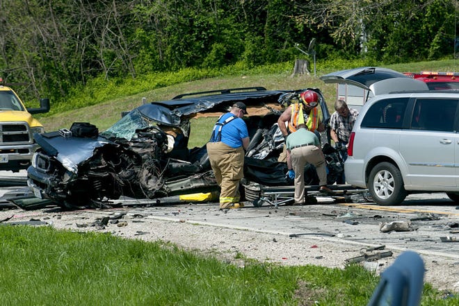 Missouri State Highway patrol officers and fire fighters remove a body from an SUV involved in a fatal collision on Highway 40 near Rocheport Thursday morning April 16, 2015.