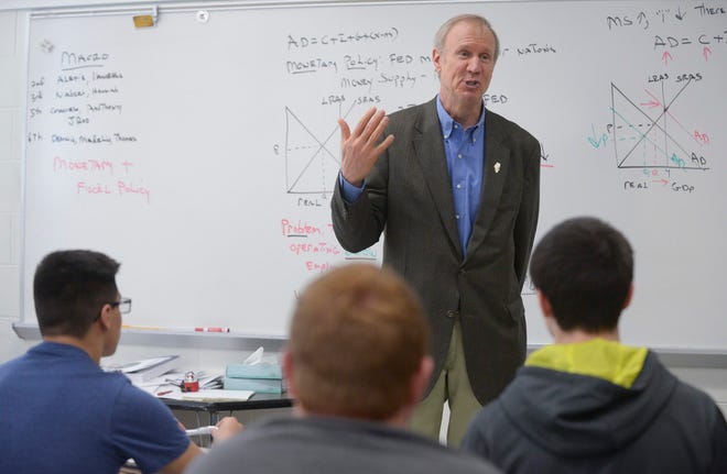 In this April 6, 2015 photo, Illinois Gov. Bruce Rauner visits an economics class at Addison Trail High School in Addison, Ill., at a stop to discuss his turnaround agenda during a tour of the state. Rauner has begun putting a finer point on his legislative agenda, telling voters, elected officials and newspaper editorial boards during the tour that his business-friendly plan is vital to improving the stateís economy. (AP Photo/Daily Herald, Mark Black) MANDATORY CREDIT, MAGS OUT