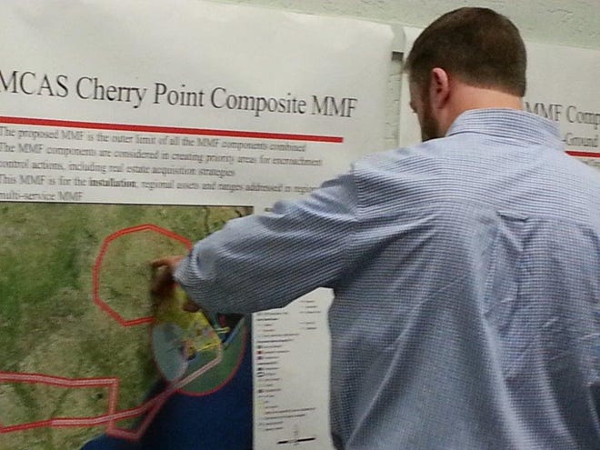 New Bern City Planner Kevin Robinson looks over maps on display at a Thursday night open house on the Cherry Point Regional Joint Land Use Study.