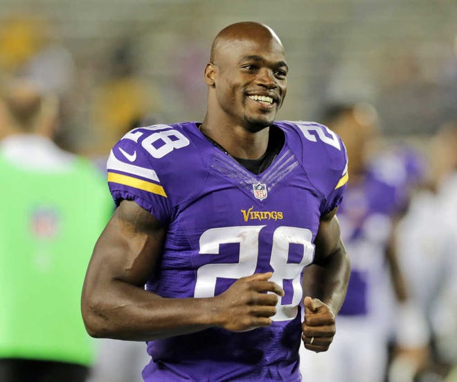 Minnesota Vikings running back Adrian Peterson leaves the field after an NFL preseason football game against the Oakland Raiders in Minneapolis on Aug. 8, 2014. The NFL has reinstated Peterson, clearing the way for him to return after missing most of last season while facing child abuse charges in Texas. The league announced its decision on Thursday, April 16.