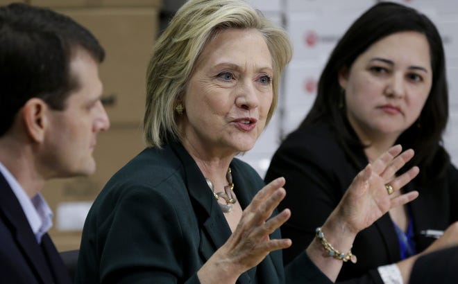 Democratic presidential candidate Hillary Rodham Clinton, center, speaks during a small business roundtable on Wednesday in Norwalk, Iowa. Charlie Neibergall/The Associated Press