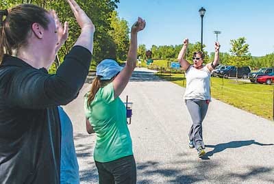 New Jersey Herald file photo - Sandy Marin of West Milford raises her arms in celebration at the end of a practice run for the “Couch to 5K” at Maple Grange Park in Vernon last year.