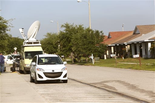Live and satellite trucks site in front of the home of Doug Hughes at 2112 Pleasant View Avenue in Ruskin on 4/16/15. Hughes landed a gyrocopter the day before on the Capital lawn. (Skip O'Rourke/The Tampa Bay Times via AP)