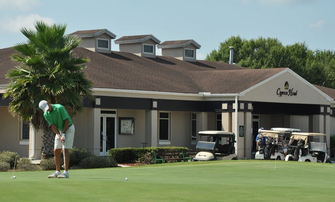 A man putts on the practice green at Cypress Head Golf Course in Port Orange.