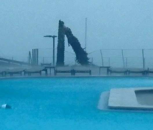 Damage is seen near a pool at Sandestin on Sunday morning. A tornado warning was in effect at the time.
