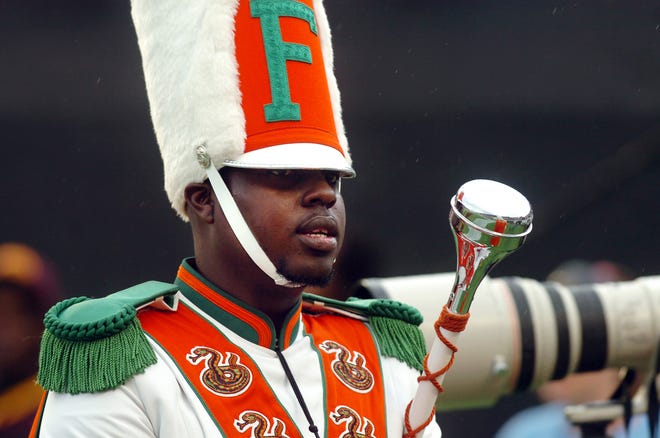 In this Saturday, Nov. 19, 2011 file photo, Robert Champion, a drum major in Florida A&M University's Marching 100 band, performs during halftime of a football game in Orlando, Fla. On Monday, April 20, 2015, the final three former band members charged with manslaughter and felony hazing in Florida A&M University drum major Robert Champion's beating death following a football game will go on trial for the November 2011 attack. (AP Photo/The Tampa Tribune, Joseph Brown III, File)